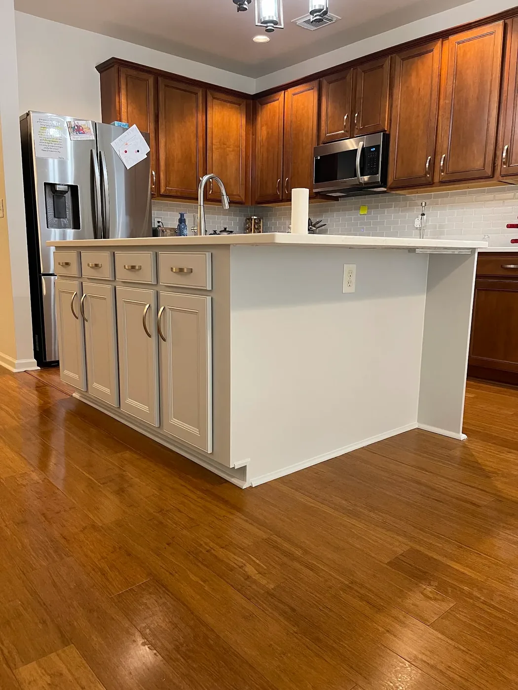 Kitchen island cabinets repainted greige in a Nashville home