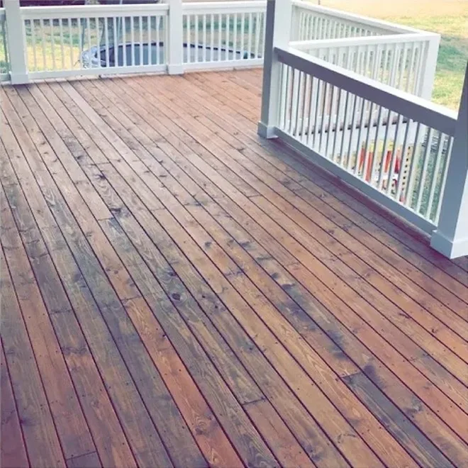 Deck boards stained warm brown with white painted railing in Middle Tennessee