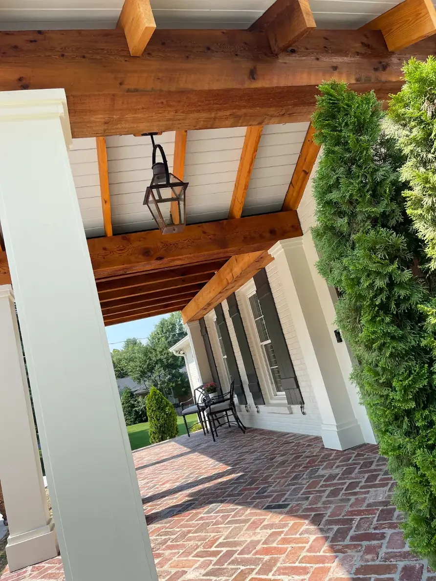 Porch ceiling, columns, and stained cedar beams after painting in Middle Tennessee