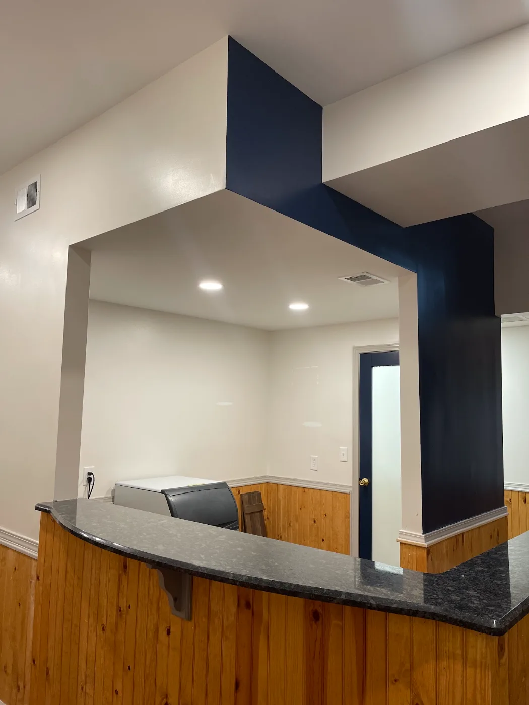 Navy accent wall and white trim after interior painting in Nashville TN