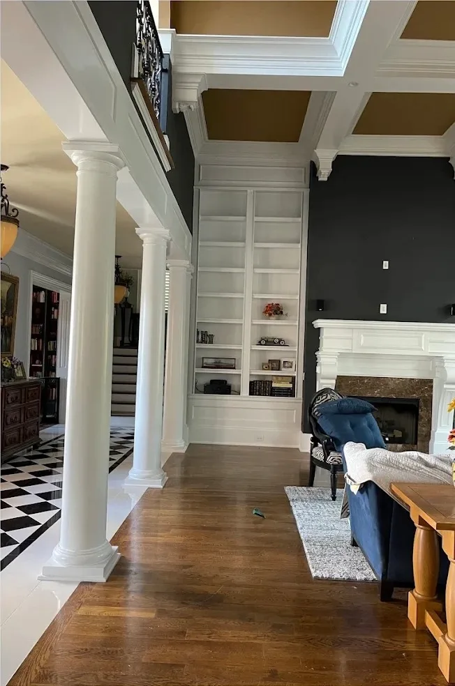 White built-in shelving, columns, and coffered ceiling trim after interior painting in Nashville TN